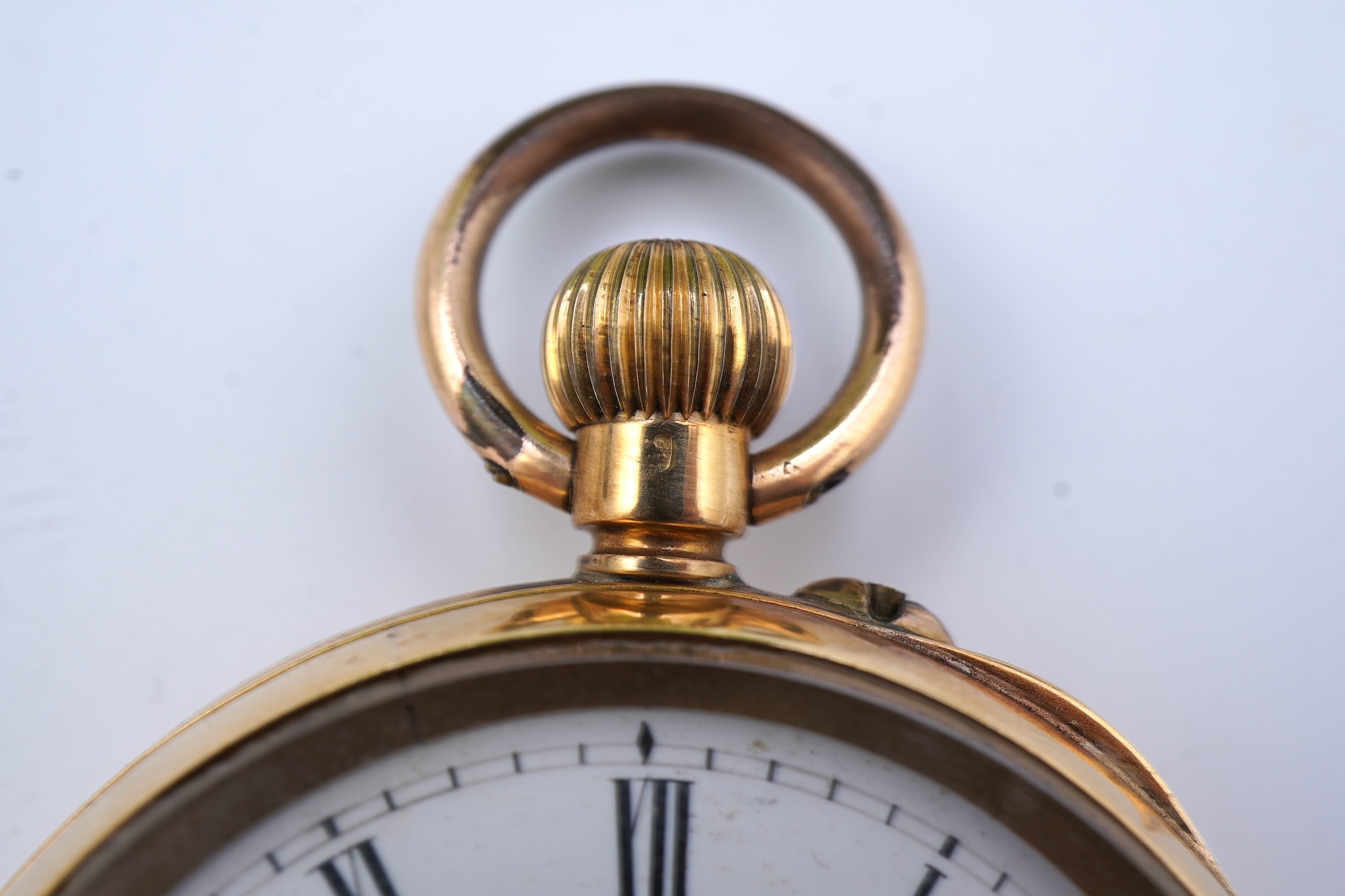A continental 18k gold open faced keyless lever pocket watch, with a 9ct albert